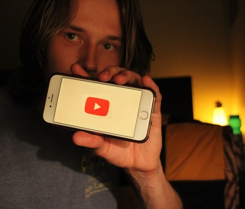 Me holding a phone with youtube on it